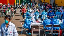 Health Ministry workers prepare to carry out coronavirus tests for employees of the Ciudad de Dios market in Lima, Peru on May 11.