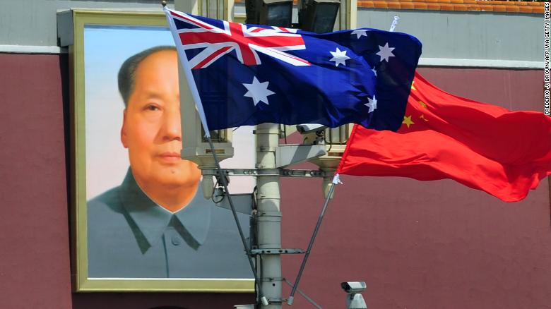 The national flags of Australia and China are displayed before a portrait of Mao Zedong facing Tiananmen Square in this file photograph from 2011.