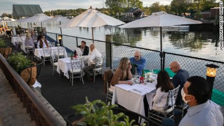 A waiter serves patrons at L'escale restaurant in Greenwich, Connecticut.