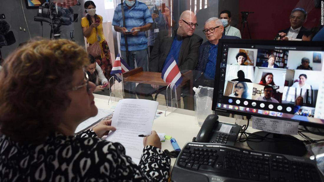 Through video conferencing, invitees watch the marriage ceremony of gay-rights activist Marco Castillo, right center, and his longtime partner, Rodrigo Campos, in San Jose, Costa Rica, May 26.