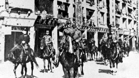 Japanese troops parade through defeated Hong Kong in 1941.