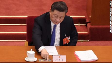 Chinese President Xi Jinping votes on a proposal on the Hong Kong security law during the closing session of the National People&#39;s Congress in Beijing on May 28.