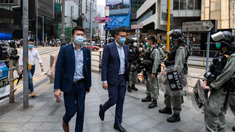 People walk past riot police on May 28, 2020 in Hong Kong, China. 