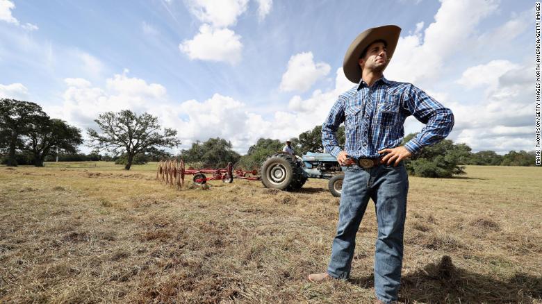  Daniel Ricciardo of Australia and Red Bull Racing works as a ranch hand for a day during previews ahead of the United States Formula One Grand Prix at Circuit of The Americas on October 19, 2016 in Austin, United States. 