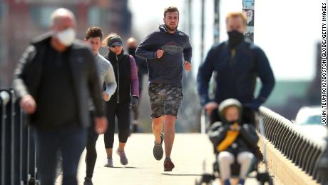 People in Boston go for a run on April 17.