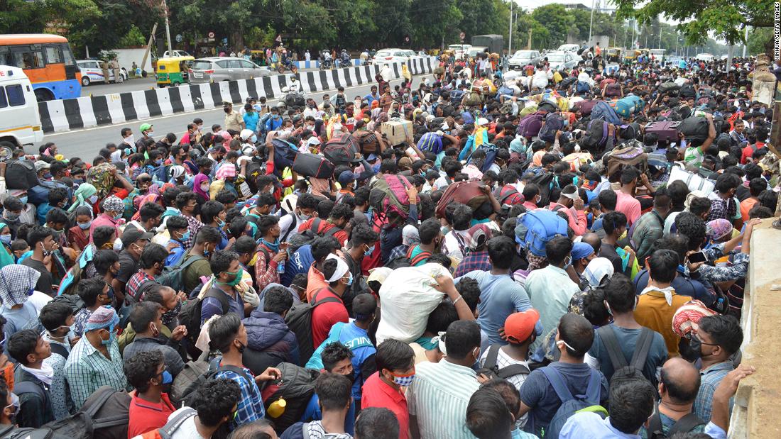 Migrant workers wait to board buses during the coronavirus lockdown in Bengaluru on May 23, 2020. 