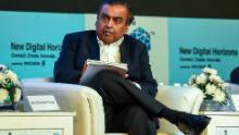 India&#39;s richest man and oil-to-telecom conglomerate Reliance Industries chairman Mukesh Ambani (R) attends the India Mobile Congress 2018 in New Delhi on October 25, 2018. - The second edition of the India Mobile Congress is taking place in New Delhi from 25-27 October. (Photo by CHANDAN KHANNA / AFP) (Photo credit should read CHANDAN KHANNA/AFP via Getty Images)