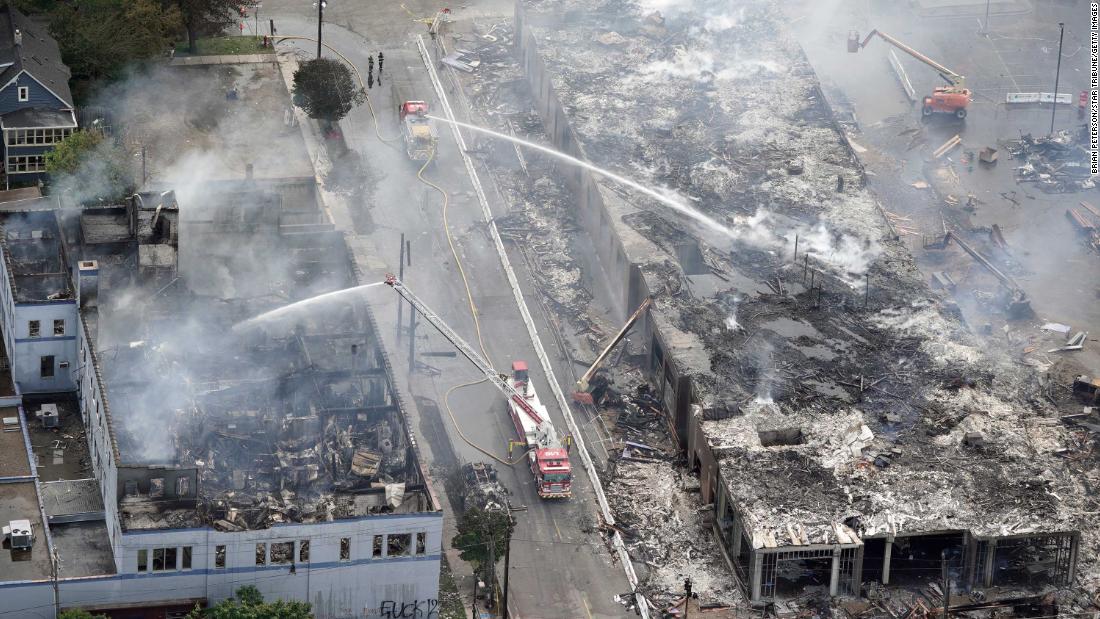 Crews work to put out fires after an apartment building under construction was burned to the ground during protests in Minneapolis on May 28.