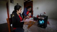 A family listens to an hour-long radio lesson from their home in Funza, Colombia, where they have no internet connection.