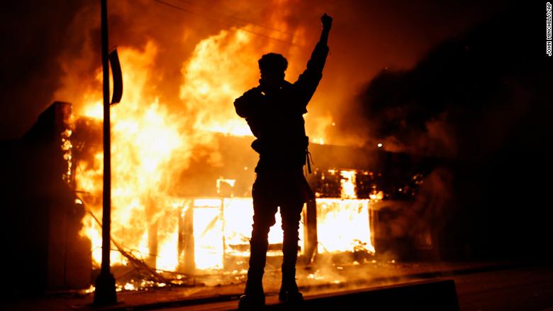 A check-cashing business burns during protests in Minneapolis on Friday. 