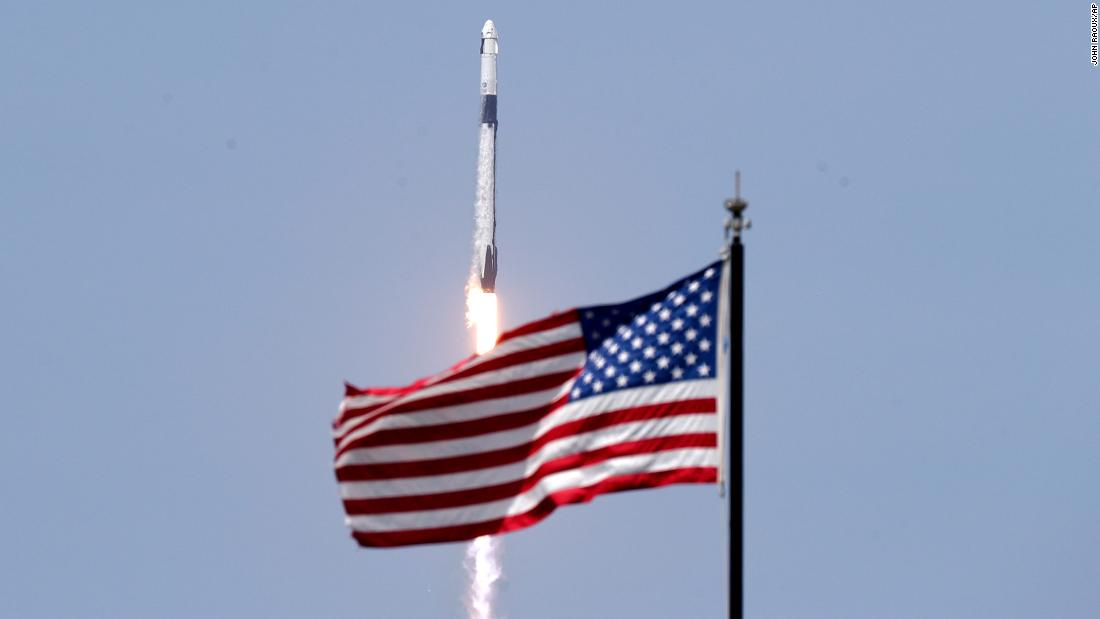 An American flag flies as the SpaceX rocket lifts off on May 30.