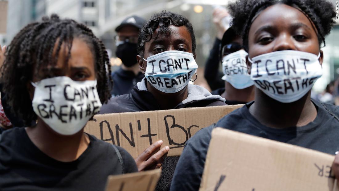 People with signs and masks that read &quot;I can&#39;t breathe&quot; attend a protest in Chicago on May 30.