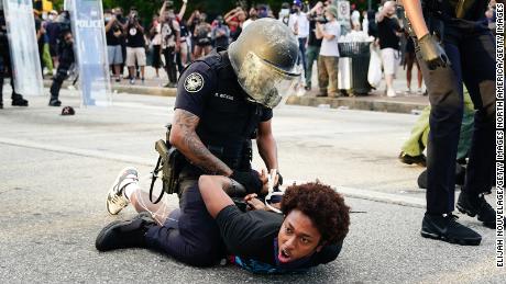 Police detain demonstrators in the street during a protest on Saturday in Atlanta.