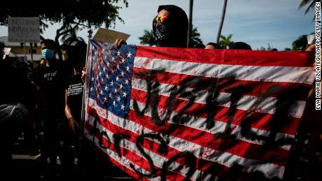 Protestors march during a rally in response to the recent death of George Floyd in Fort Lauderdale, Florida on May 31, 2020. - Thousands of National Guard troops patrolled major US cities  after five consecutive nights of protests over racism and police brutality that boiled over into arson and looting, sending shock waves through the country. The death Monday of an unarmed black man, George Floyd, at the hands of police in Minneapolis ignited this latest wave of outrage in the US over law enforcement's repeated use of lethal force against African Americans -- this one like others before captured on cellphone video. (Photo by Eva Marie UZCATEGUI / AFP) (Photo by EVA MARIE UZCATEGUI/AFP via Getty Images)