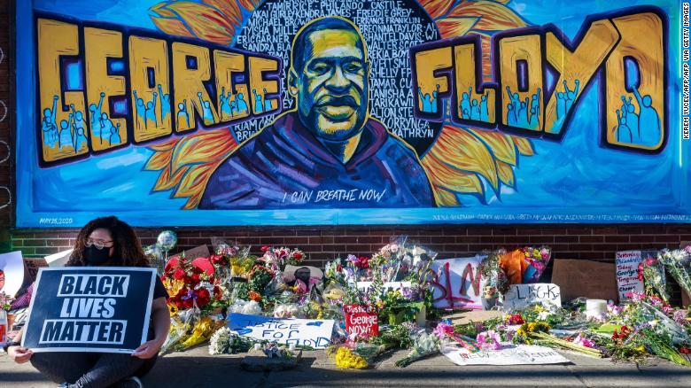 Flowers, signs and balloons are left near a makeshift memorial to George Floyd near the spot where he died while in custody of the Minneapolis police.