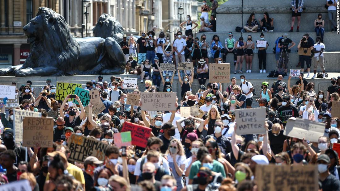 People hold placards as they join a Black Lives Matter march at Trafalgar Square in London on Sunday, May 31.