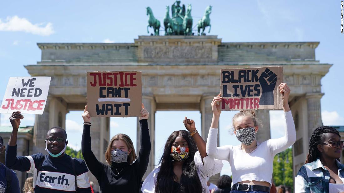 People attend a rally against racism in front of the Brandenburg Gate in Berlin on Sunday, May 31. 