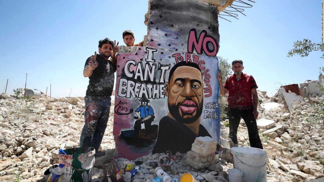 Aziz Asmar and Anis Hamdoun stand with their mural.