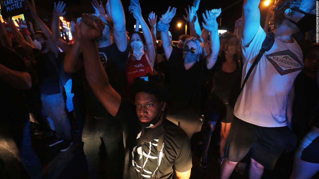 A protester kneels in front of a police line in Memphis, Tennessee, on May 31.