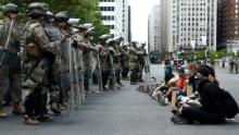 Protesters rally in front of Pennsylvania National Guard soldiers, Monday, June 1, 2020, in Philadelphia, over the death of George Floyd, a black man who was in police custody in Minneapolis. Floyd died after being restrained by Minneapolis police officers on May 25. (AP Photo/Matt Slocum)