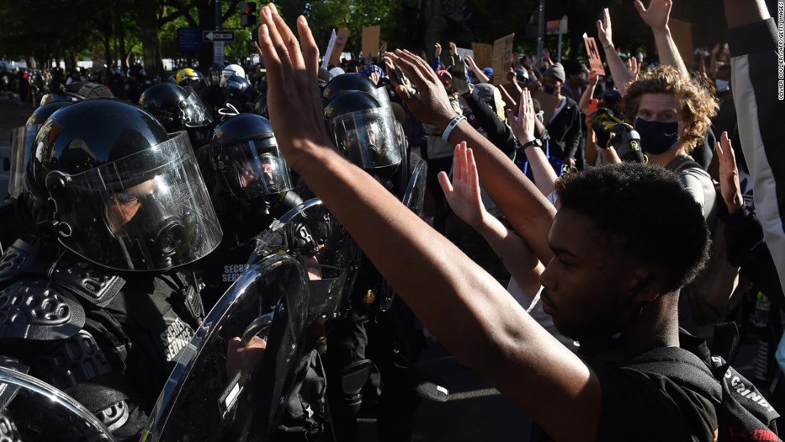Police and demonstrators face off outside the White House in Washington on Monday, June 1. Moments later, police dispersed the crowd with tear gas, flash bangs and rubber bullets.