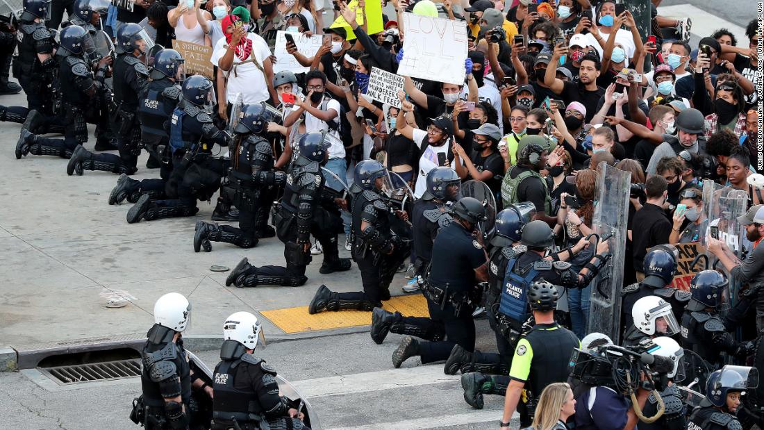 Law enforcement officers kneel with protesters in Atlanta on June 1.