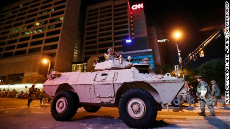 The Georgia Army National Guard mans an armored security vehicle outside the CNN Center to help manage protesters Monday in Atlanta.