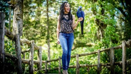 Wildlife conservationist Corina Newsome and Tony, a Hyacinth Macaw.