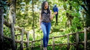 Wildlife conservationist Corina Newsome and Tony, a Hyacinth Macaw.