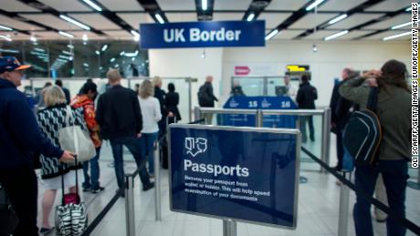 Border Force check the passports of passengers arriving at Gatwick Airport on May 28, 2014 in London, UK. Changes to BNO status could grant hundreds of thousands of Hong Kongers new rights of abode. 