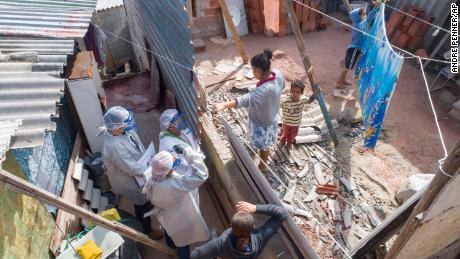 Health workers from Doctors Without Borders visit a squat in Sao Bernardo do Campo, Brazil.