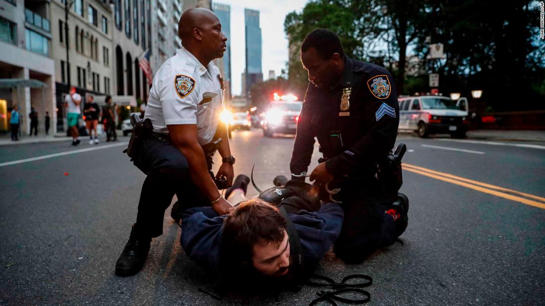 A protester is arrested for violating curfew near the Plaza Hotel in New York on June 3.