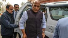India's Defence Minister Rajnath Singh (C) arrives at the Parliament in New Delhi on February 11.
