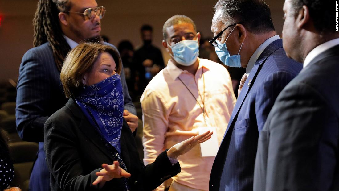 US Sen. Amy Klobuchar talks with the Rev. Jesse Jackson at the service.