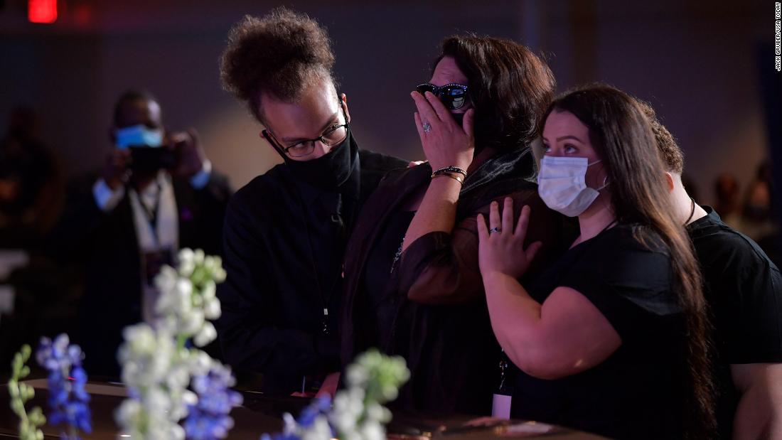 Mourners spend a moment at Floyd&#39;s casket ahead of the service.