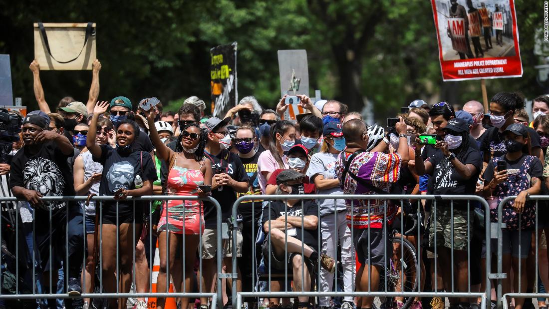 People stand outside to show their support during Floyd&#39;s service in Minneapolis.