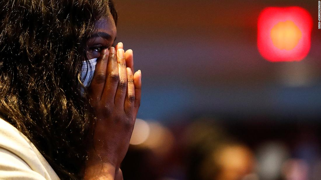 A woman reacts during Thursday&#39;s service.