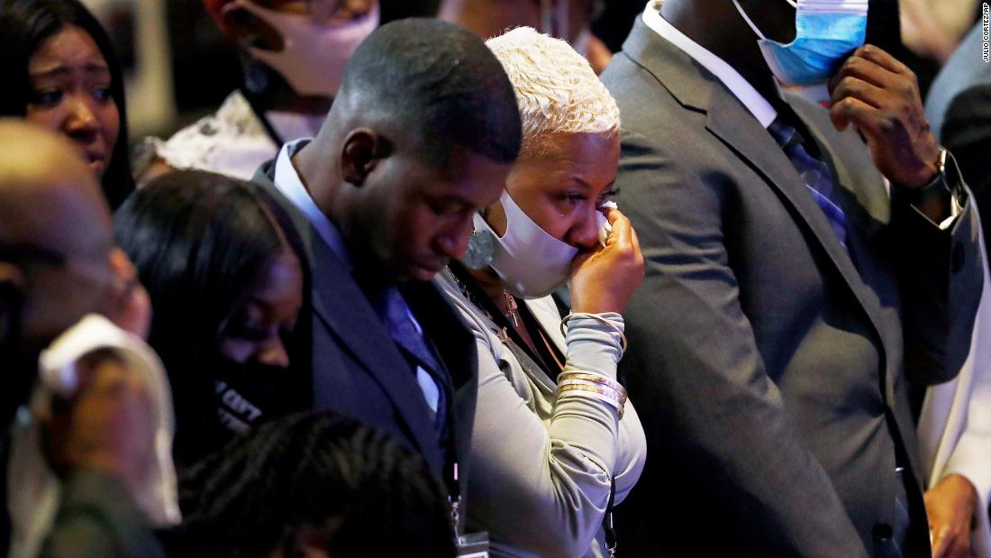 People at the Minneapolis memorial stood in silence for eight minutes and 46 seconds -— the length of time that Derek Chauvin, the former Minneapolis police officer charged with killing Floyd, had his knee on Floyd&#39;s neck. At center here is Floyd&#39;s cousin Shareeduh Tate, who grew up with him and spoke during the service.