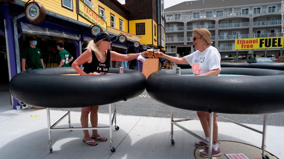 People try out &lt;a href=&quot;http://www.cnn.com/travel/article/coronavirus-restaurant-bumper-tables-trnd/index.html&quot; target=&quot;_blank&quot;&gt;social-distancing &quot;bumper tables&quot;&lt;/a&gt; as the Fish Tales restaurant opened for in-person dining in Ocean City, Maryland, on May 29.