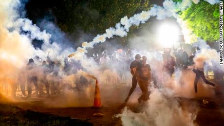 Tear gas rises above protesters during a demonstration outside the White House on Sunday.