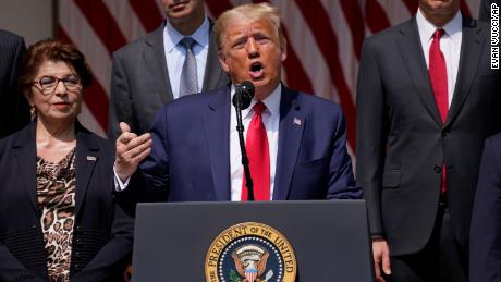President Donald Trump speaks during a news conference in the Rose Garden of the White House, Friday, June 5, 2020, in Washington. Front row from left, Small Business Administration administrator Jovita Carranza, Trump, and Vice President Mike Pence. Back row from left, member of Council of Economic Advisers Tyler Goodspeed, Labor Secretary Eugene Scalia, Treasury Secretary Steven Mnuchin, and Chairman of the Council of Economic Advisers Tomas Philipson.(AP Photo/Evan Vucci)