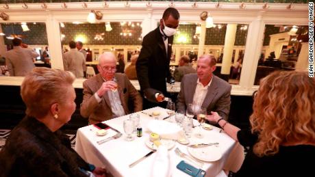 NEW ORLEANS, LOUISIANA - MAY 22: A waiter pours wine during dinner at Galatoire&#39;s Restaurant on May 22, 2020 in New Orleans, Louisiana. The City of New Orleans, which has suffered over 2,500 deaths due to the COVID-19 pandemic, began allowing restaurants to reopen at 25% capacity during Phase 1 of reopening. (Photo by Sean Gardner/Getty Images)