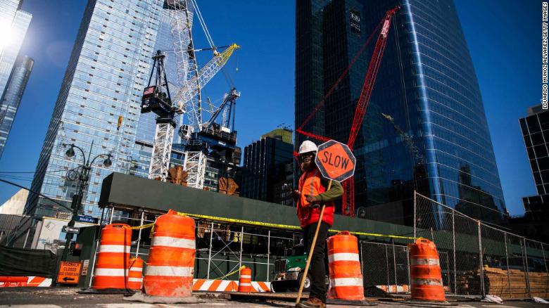 NEW YORK, NY - MARCH 26: A Construction worker takes care of traffic as they build a new tower on March 26, 2020 in New York City. Some construction workers building luxury condominiums are being forced to work in the city by their companies, while across the country schools, businesses and places of work have either been shut down or are restricting hours of operation as health officials try to slow the spread of COVID-19. (Photo by Eduardo Munoz Alvarez/Getty Images)