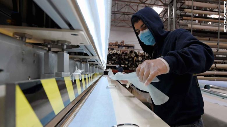 LAS VEGAS, NEVADA - APRIL 14:  Johnny Diaz makes surgical masks out of spunbond polypropylene fabric using an impulse welder at Polar Shades Sun Control to help Las Vegas-area health care workers and first responders fighting the coronavirus on April 14, 2020 in Las Vegas, Nevada. The company&#39;s facility transitioned from making items like window coverings, screen doors and drapery tracks to mass-producing protective gowns and surgical masks amid the pandemic. Polar Shades employees have sent out more than 40,000 gowns and 12,000 masks at cost since starting the new operation on March 22nd. The World Health Organization declared the coronavirus (COVID-19) a pandemic on March 11th.  (Photo by Ethan Miller/Getty Images)