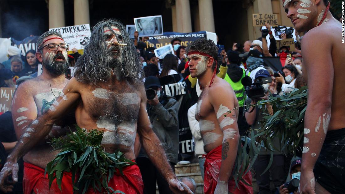 Aboriginal protesters conduct a traditional smoking ceremony at Town Hall in Sydney, Australia, on June 6.