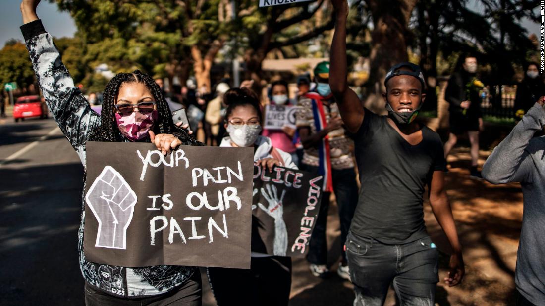 People march from the US Embassy in Pretoria, South Africa, towards the President&#39;s office.