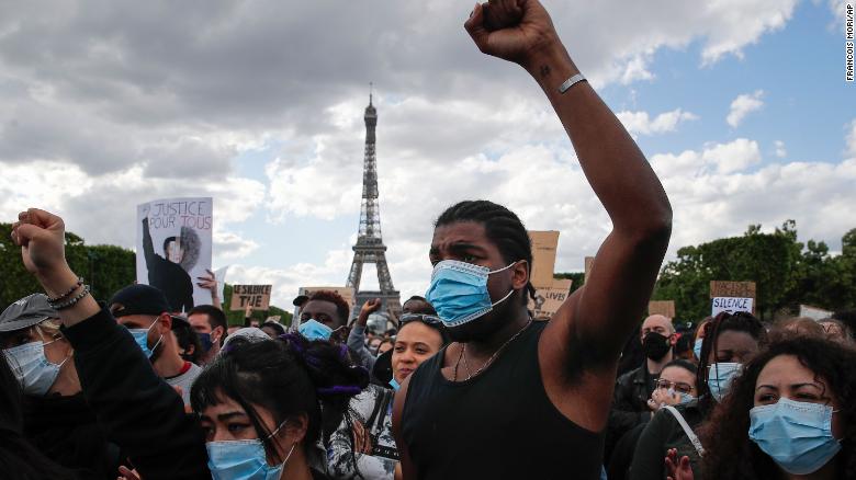 Demonstrators gather on the Champs de Mars in front of the Eiffel Tower during a demonstration in Paris Saturday.