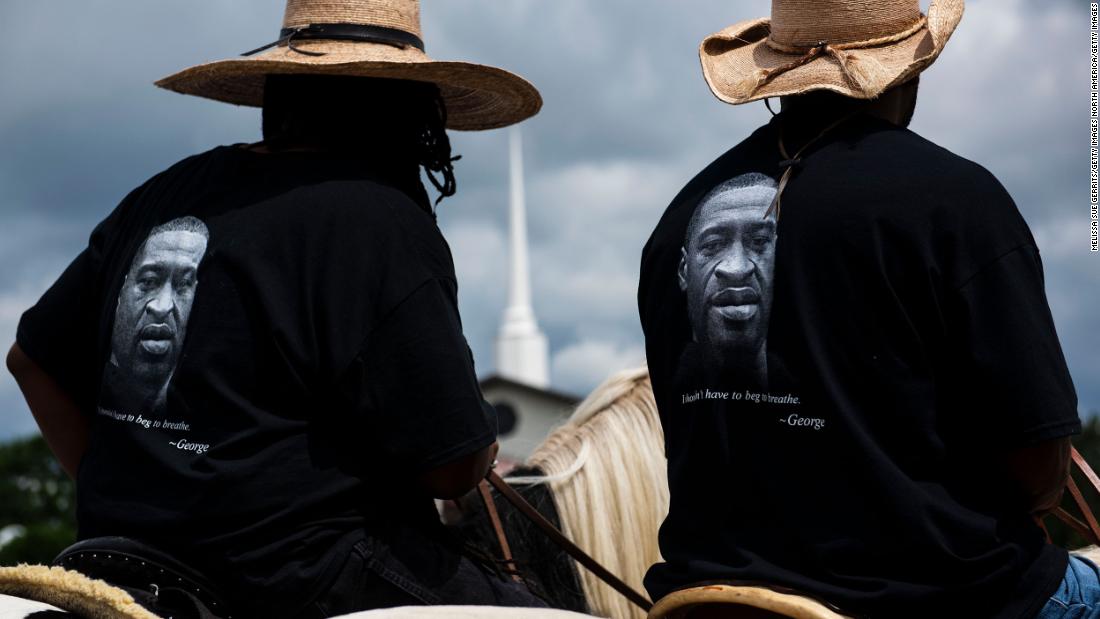 Members of a local Black Cowboys club ride their horses through the parking lot outside a Floyd memorial service in Raeford, North Carolina, on Saturday.