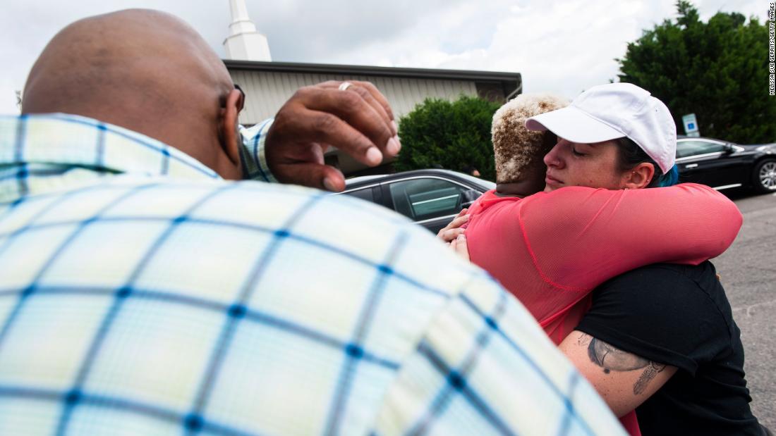 Nakia Almond hugs Erin Corner after praying together outside of Floyd&#39;s memorial service in Raeford.