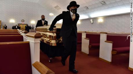 A gold casket holding the remains of George Floyd arrived in Raeford, North Carolina, on Saturday for a memorial and viewing service.